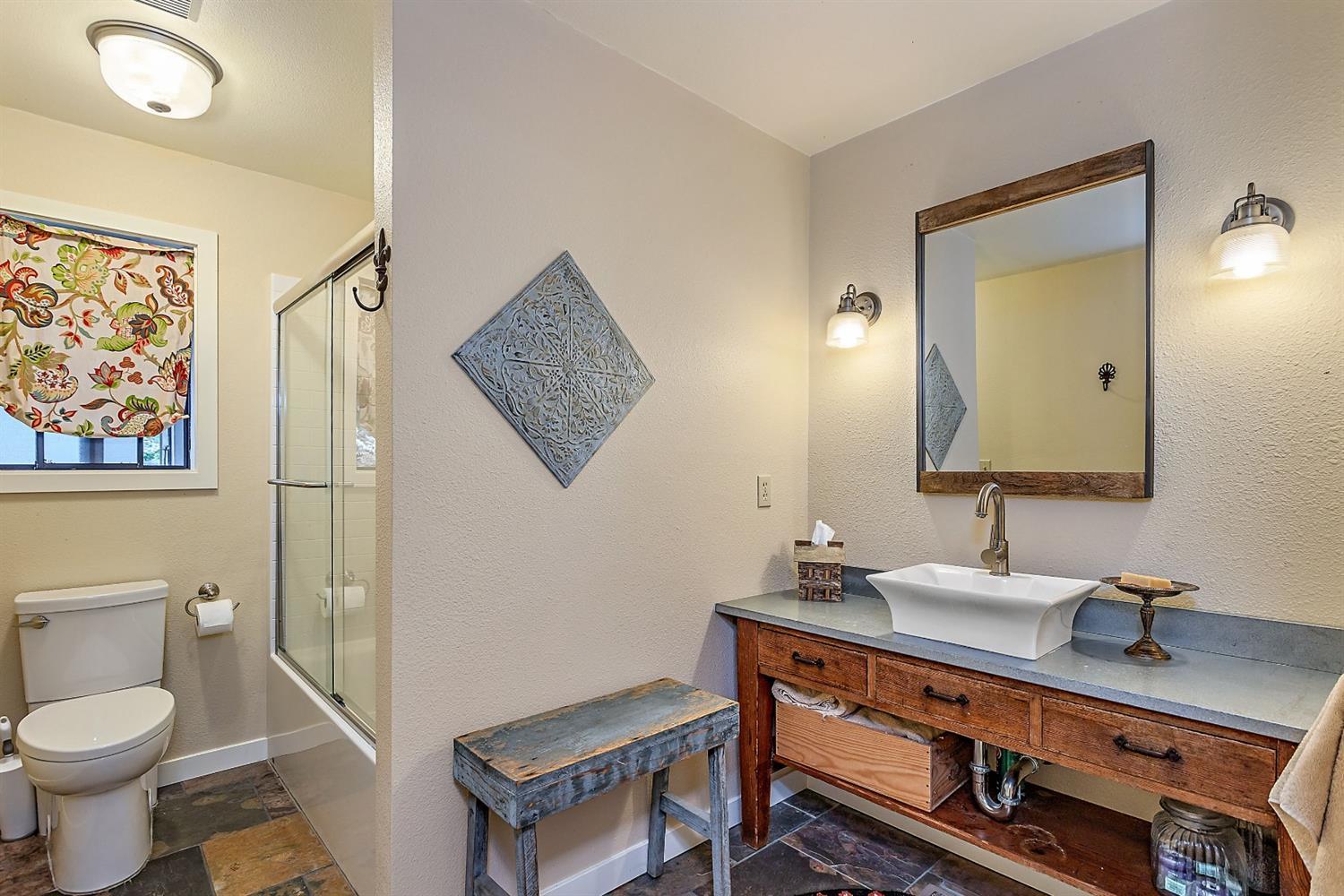 9155 North Applegate Road Grants Pass, OR 97527 - Photo 23 of 35 a bathroom with a sink mirror vanity and toilet