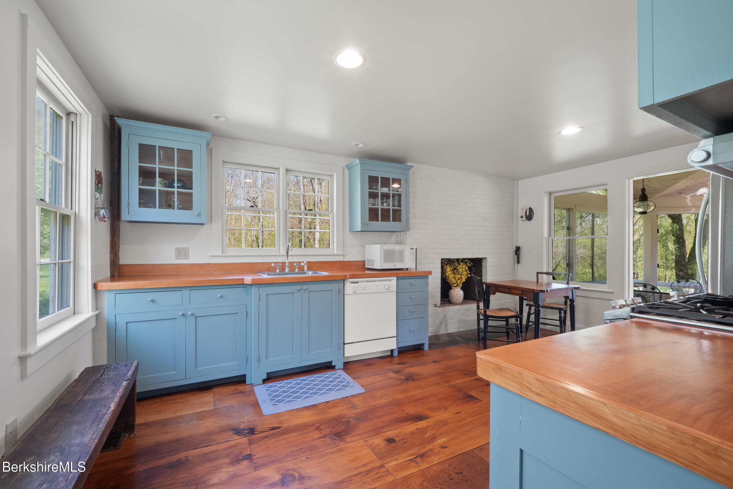 350 Beartown Mountain Road Monterey, MA 01245 - Photo 11 of 38 a kitchen with sink cabinets and wooden floor