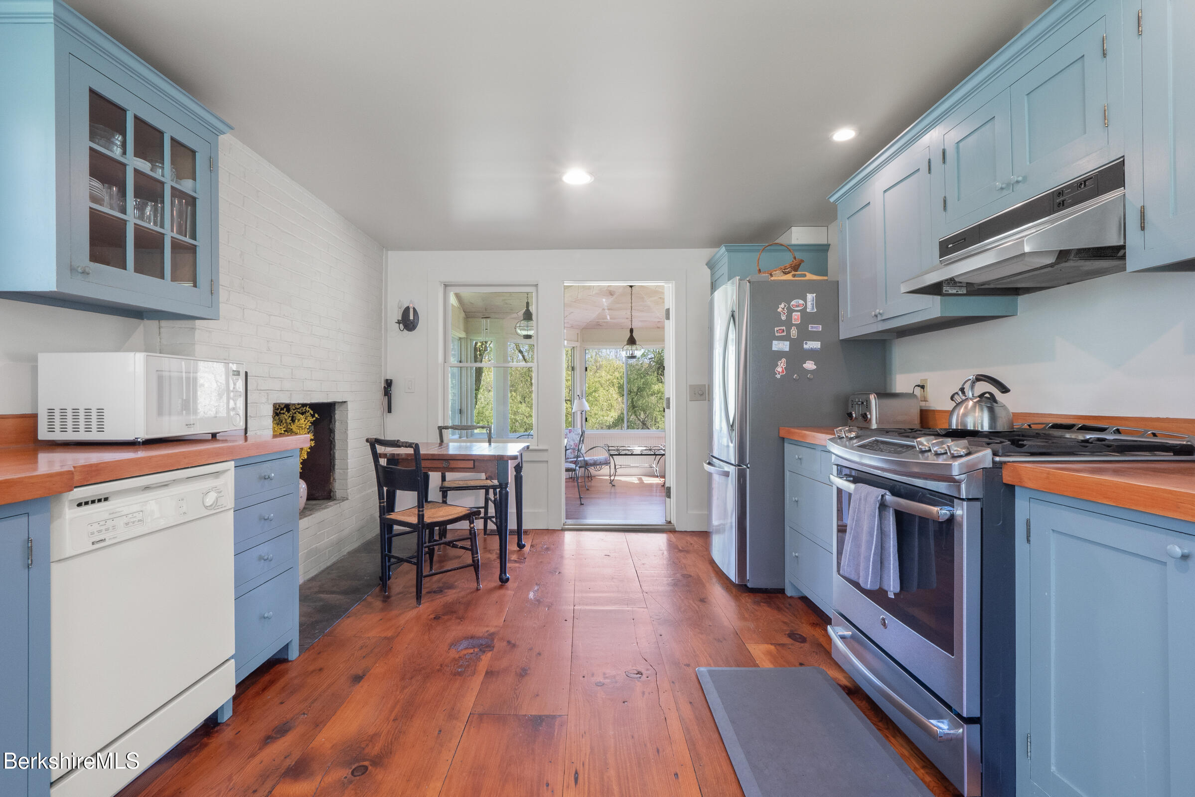 350 Beartown Mountain Road Monterey, MA 01245 - Photo 13 of 38 a kitchen with stainless steel appliances granite countertop wooden floors and stove top oven
