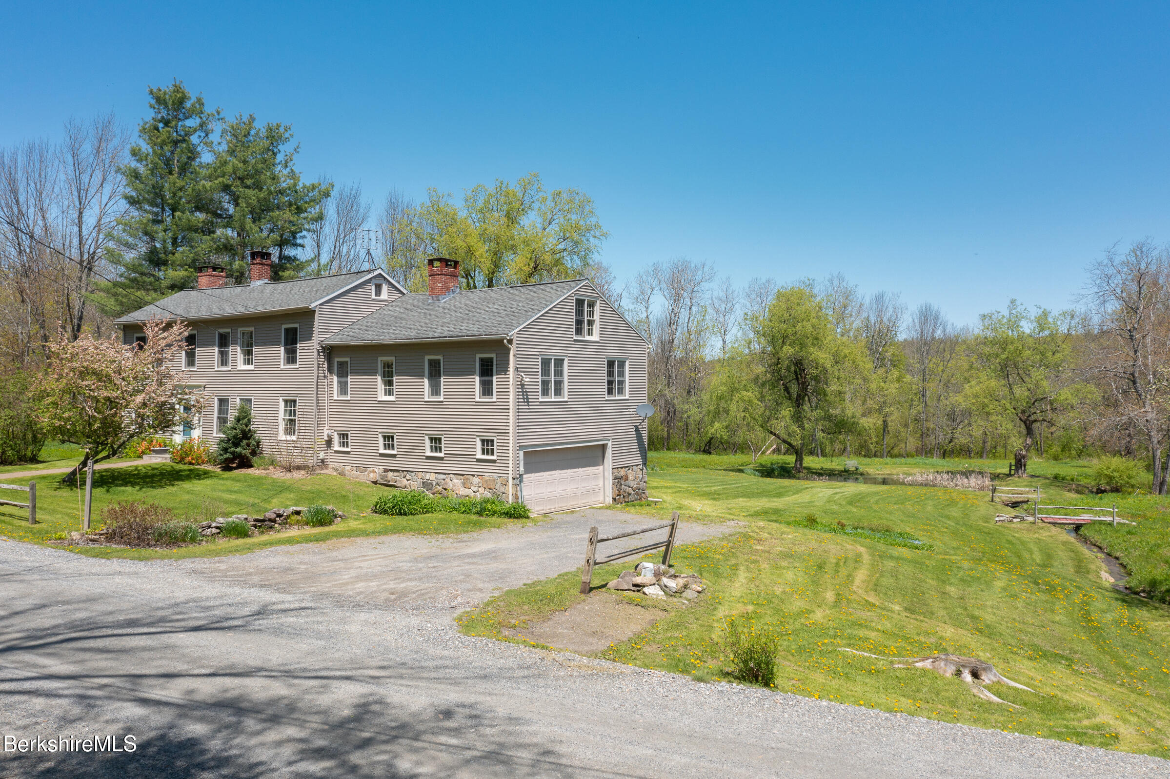 350 Beartown Mountain Road Monterey, MA 01245 - Photo 3 of 38 a front view of a house with garden