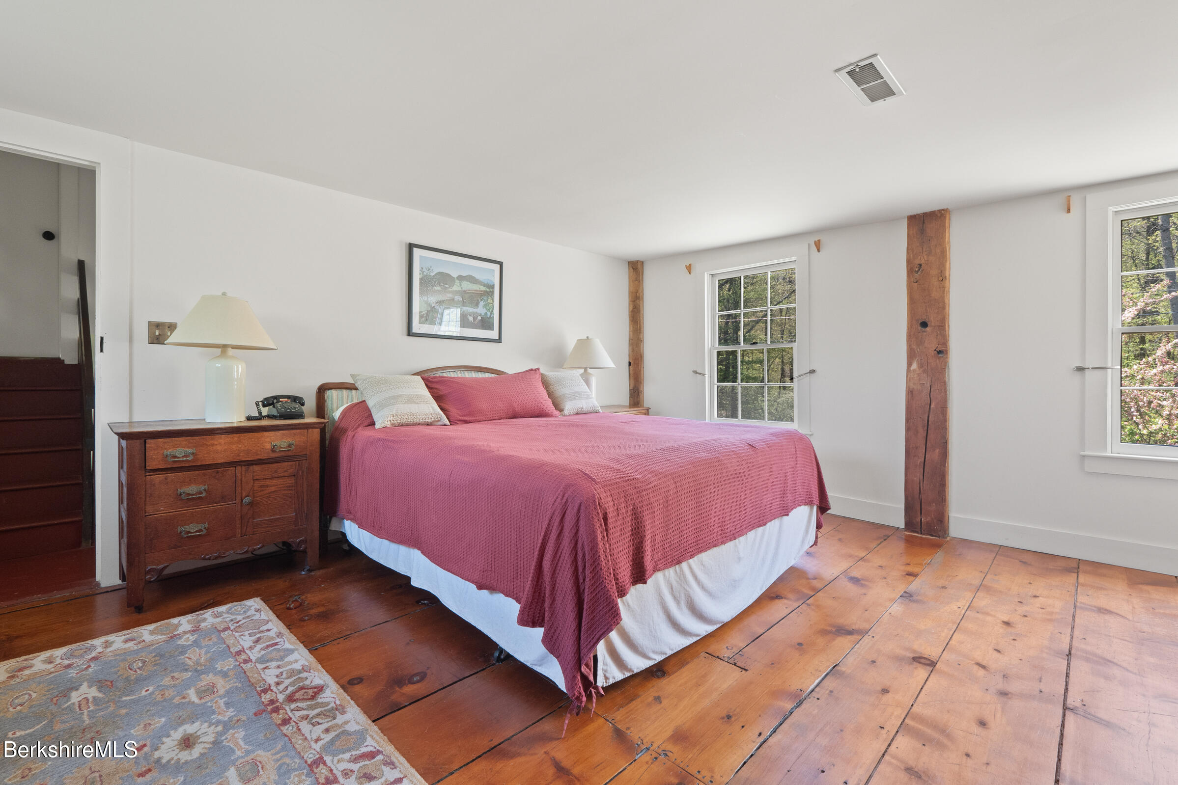 350 Beartown Mountain Road Monterey, MA 01245 - Photo 31 of 38 a spacious bedroom with a large bed and a window