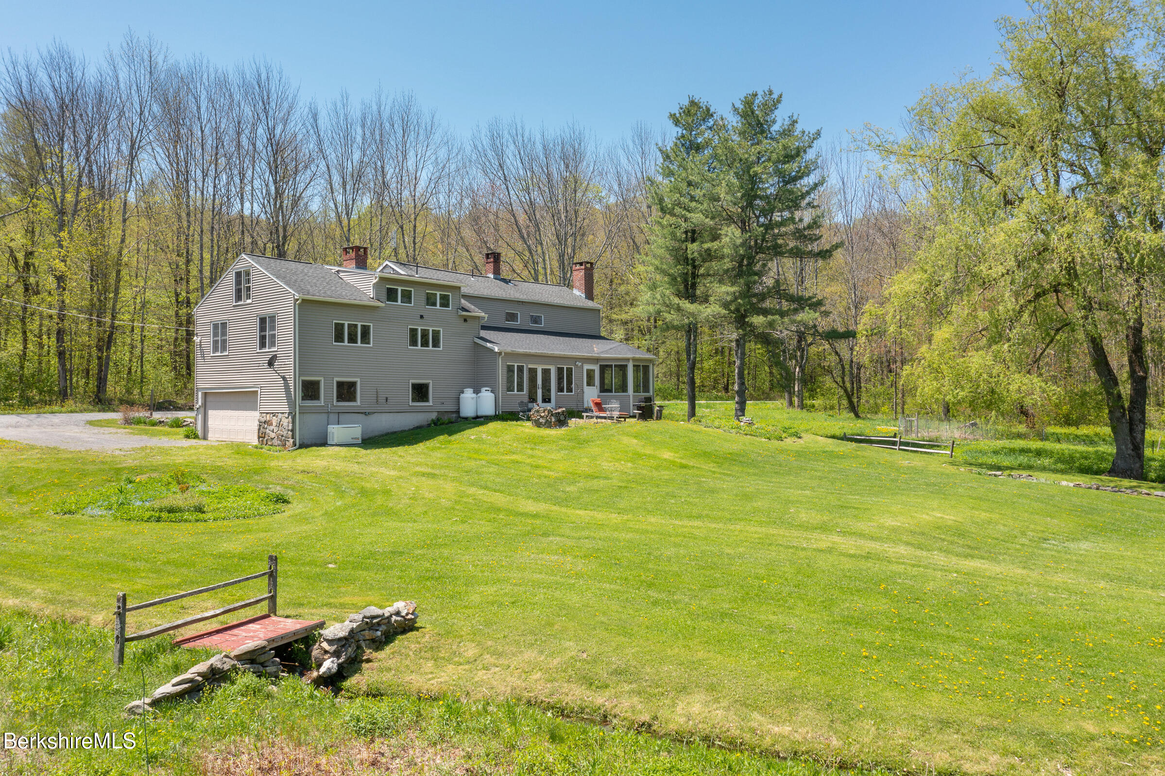 350 Beartown Mountain Road Monterey, MA 01245 - Photo 35 of 38 a garden with trees in front of it