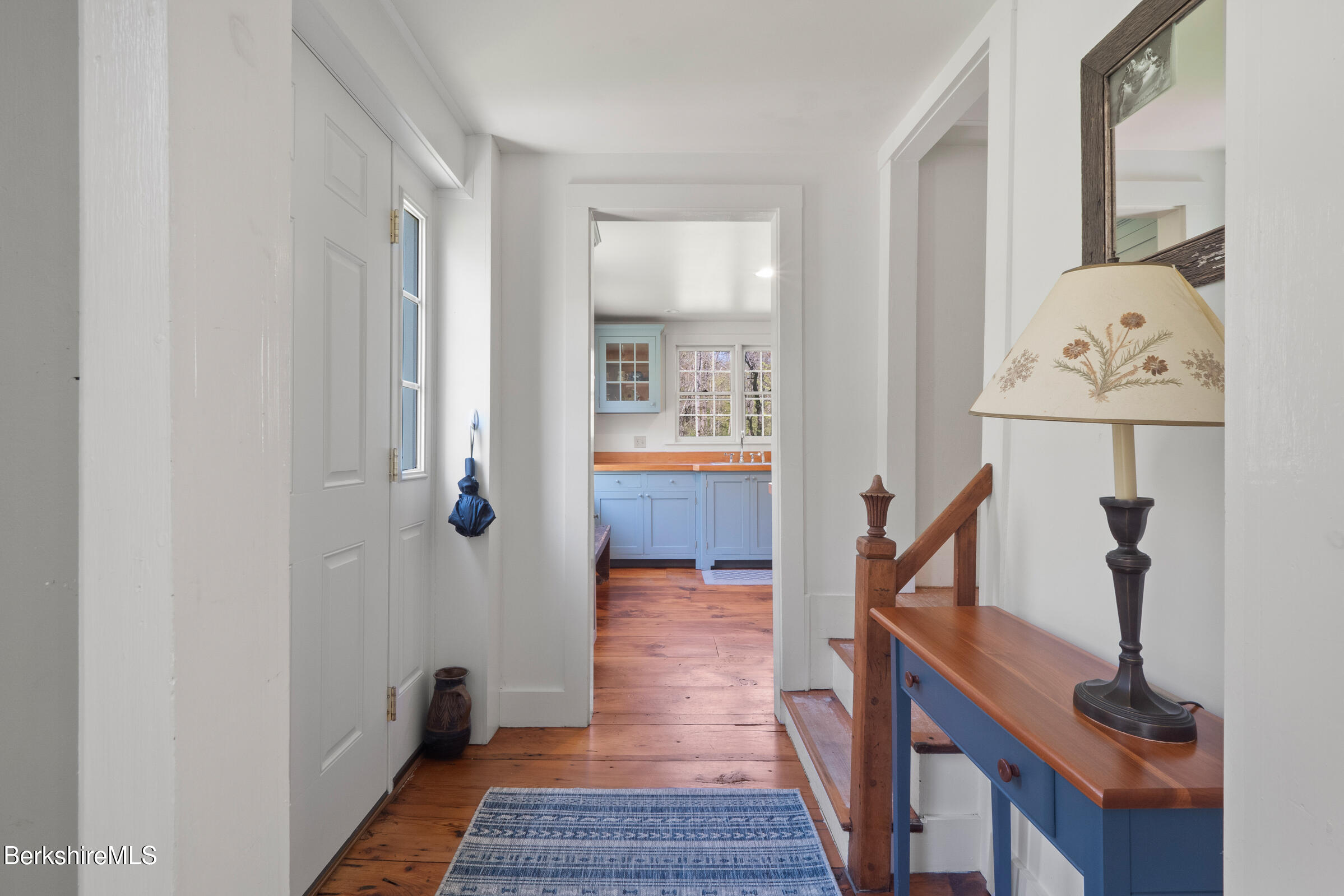 350 Beartown Mountain Road Monterey, MA 01245 - Photo 10 of 38 a view of a hallway with wooden floor and a living room
