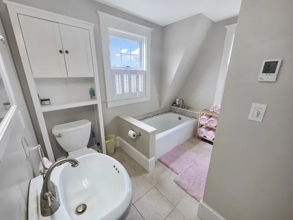 a bathroom with a sink and mirror with toilet