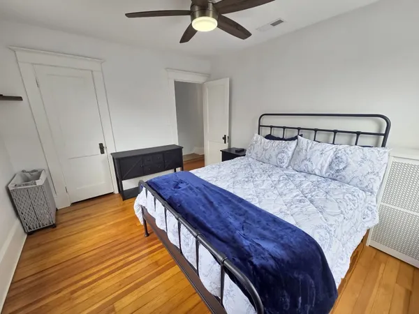 a bedroom with a bed and a dresser