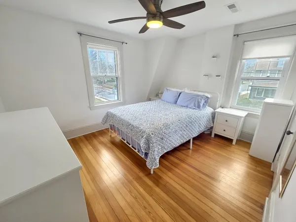 a living room with a bed furniture and a window