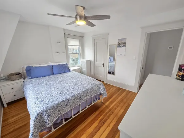 a bedroom with a bed and a dresser