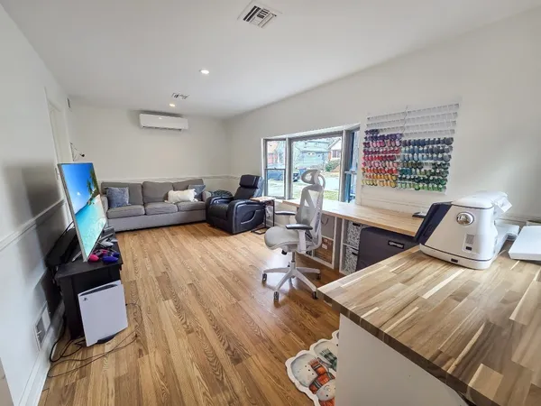 a living room with furniture and wooden floor