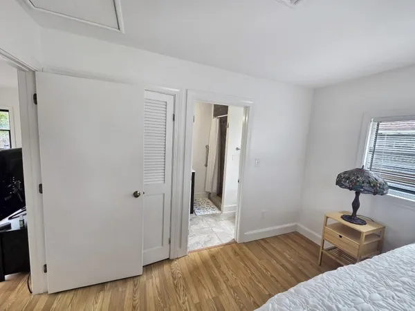 a bedroom with two beds and a window