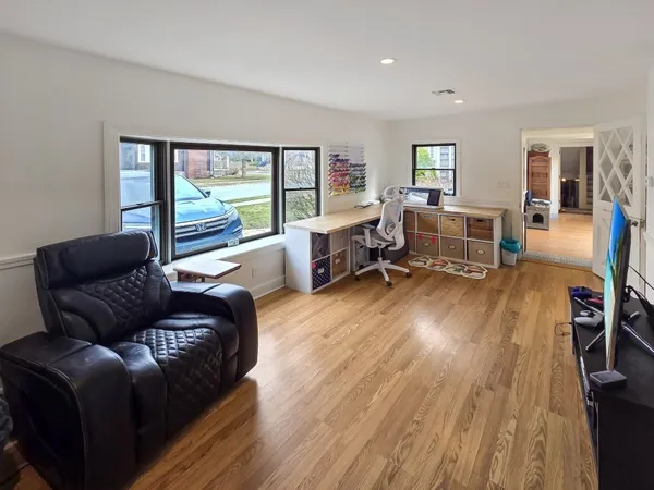 a living room with furniture and a wooden floor