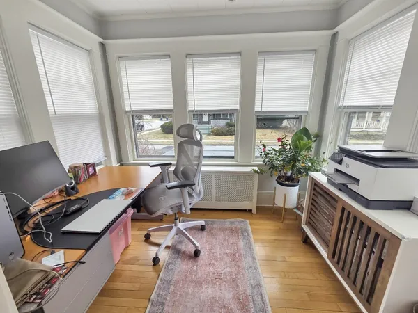 a room with wooden floor and furniture