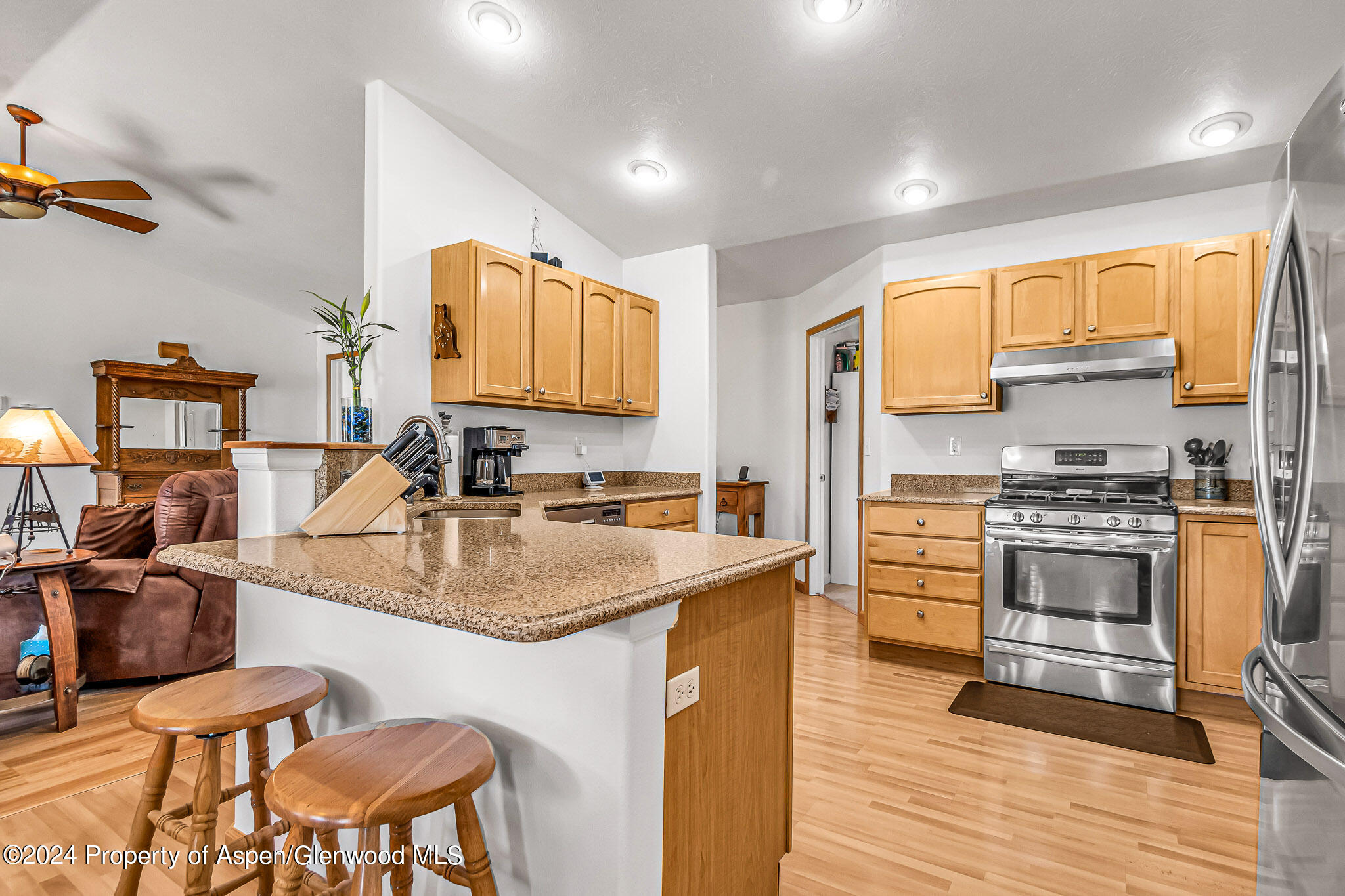 1412 Graham Court Rifle, CO 81650 - Photo 9 of 30 a kitchen with stainless steel appliances granite countertop a sink stove and refrigerator