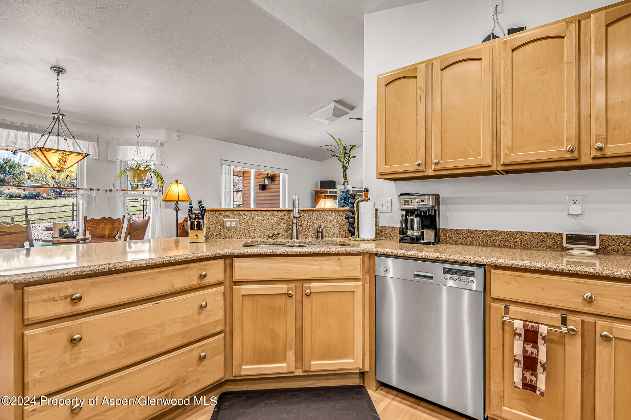 1412 Graham Court Rifle, CO 81650 - Photo 10 of 30 a kitchen with granite countertop white cabinets and white appliances