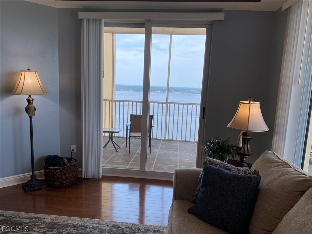 2743 First Street, Unit 2206 Fort Myers, FL 33916 - Photo 14 of 38 a living room with furniture and a lamp