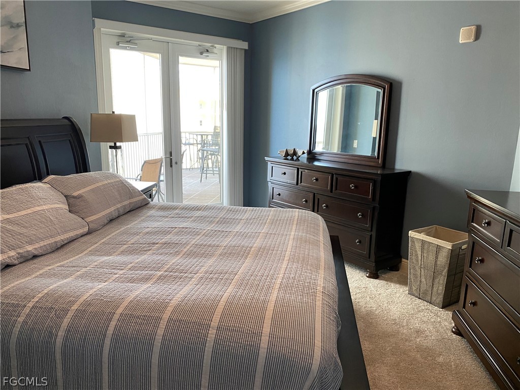 2743 First Street, Unit 2206 Fort Myers, FL 33916 - Photo 19 of 38 a bedroom with a bed and a mirror on dresser