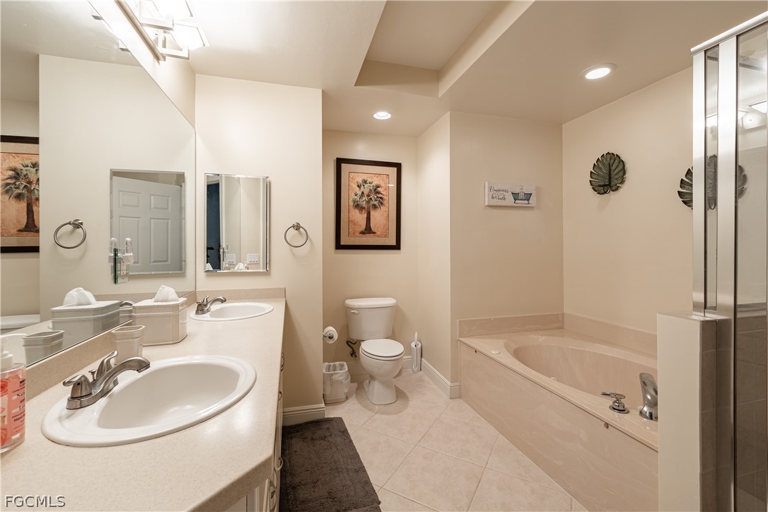 2743 First Street, Unit 2206 Fort Myers, FL 33916 - Photo 22 of 38 a bathroom with a sink a toilet and shower