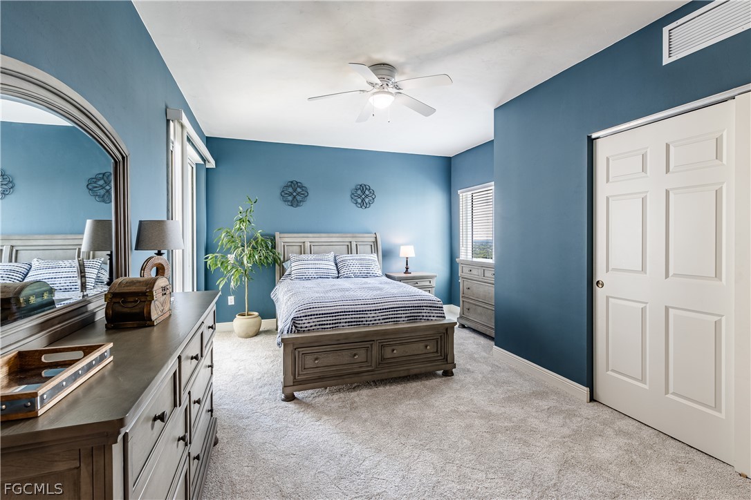 2743 First Street, Unit 2206 Fort Myers, FL 33916 - Photo 24 of 38 a bedroom with a bed and a chandelier