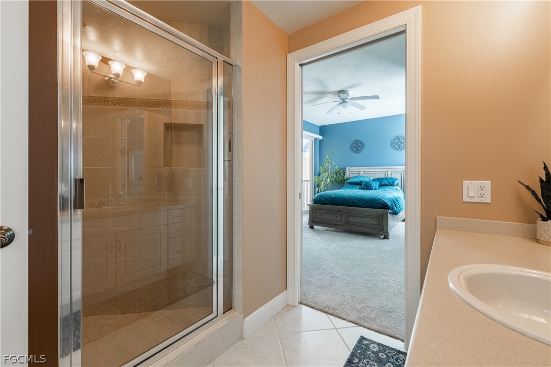 2743 First Street, Unit 2206 Fort Myers, FL 33916 - Photo 28 of 38 a en suite bathroom with a shower sink and mirror