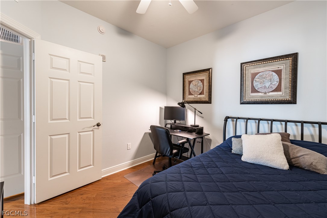 2743 First Street, Unit 2206 Fort Myers, FL 33916 - Photo 31 of 38 a bedroom with a bed and wooden floor