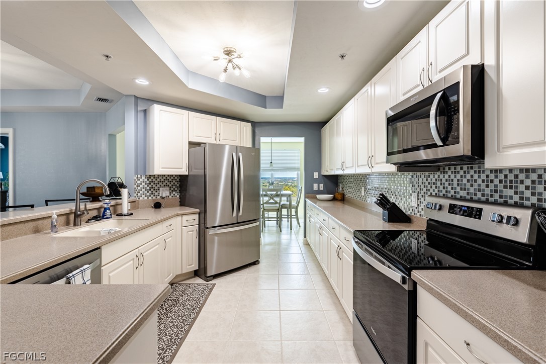 2743 First Street, Unit 2206 Fort Myers, FL 33916 - Photo 5 of 38 a kitchen with stainless steel appliances granite countertop a stove a sink and a microwave