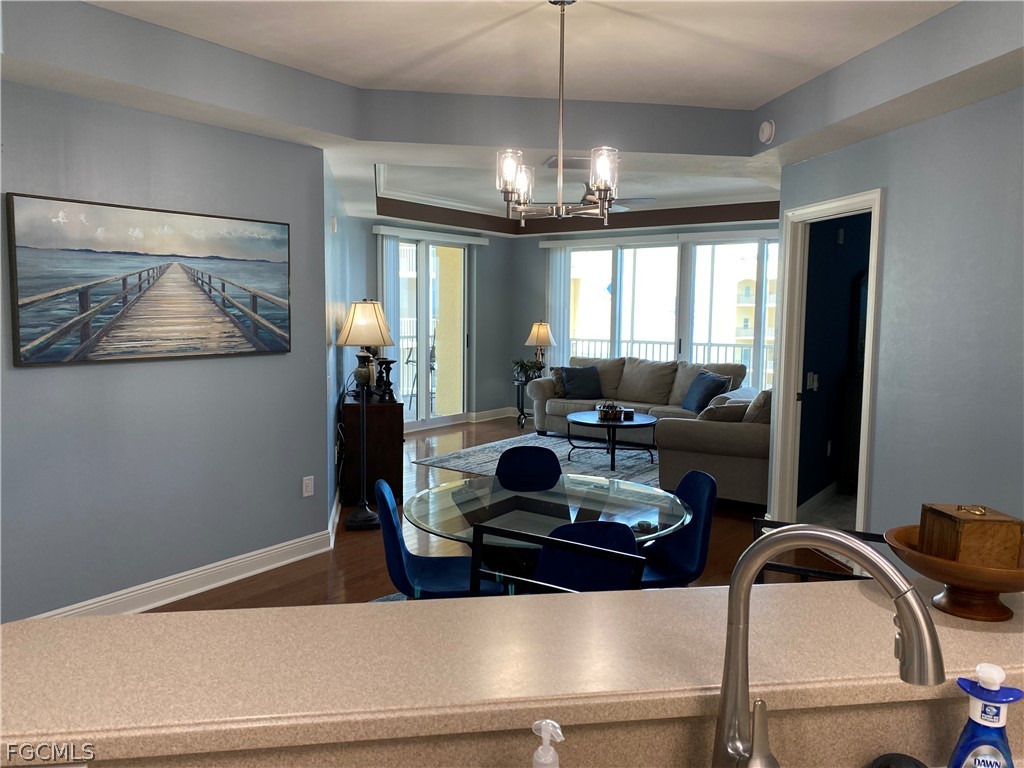 2743 First Street, Unit 2206 Fort Myers, FL 33916 - Photo 7 of 38 a living room with furniture and a chandelier