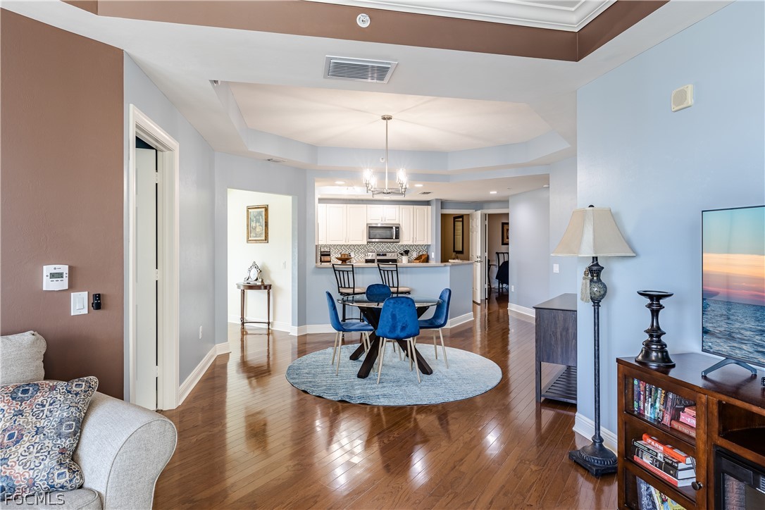 2743 First Street, Unit 2206 Fort Myers, FL 33916 - Photo 9 of 38 a living room with furniture and a chandelier