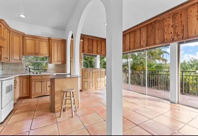 a view of kitchen with furniture and large window