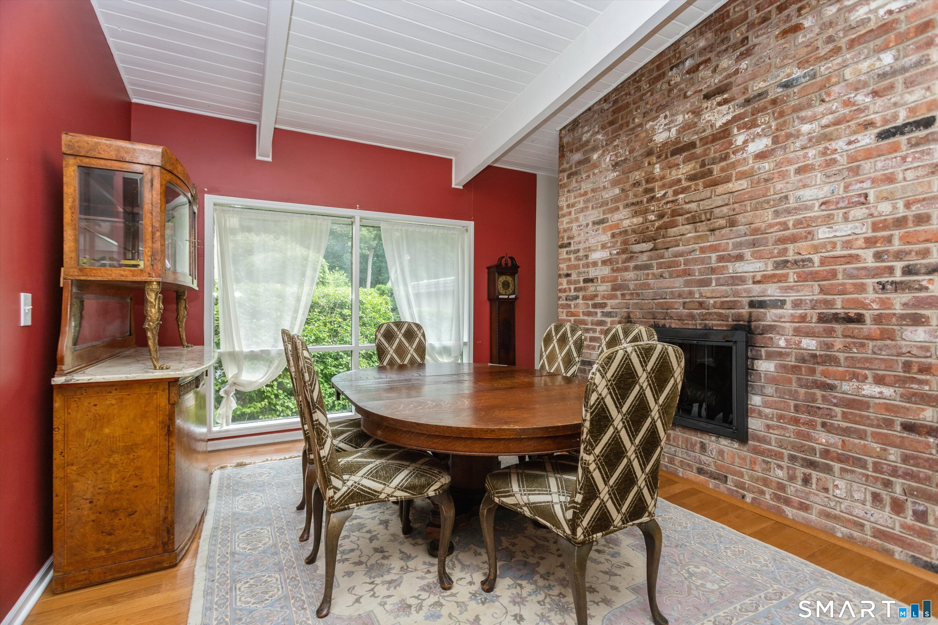 106 Gillies Lane, Unit 106 Norwalk, CT 06854 - Photo 12 of 36 Dining room with double sided fireplace
