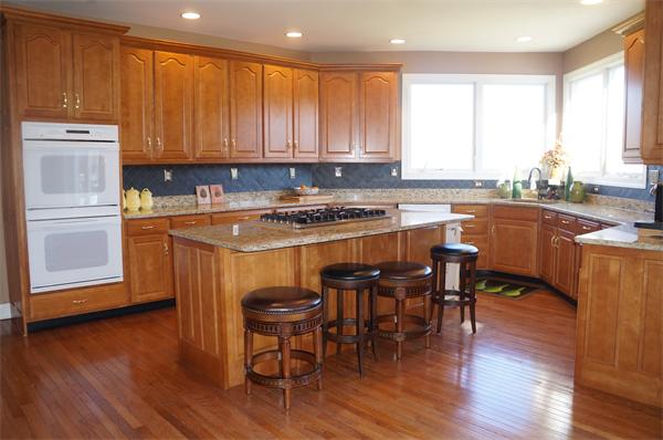32 Cherokee Road Canton, MA 02021 - Photo 3 of 30 a kitchen with stainless steel appliances granite countertop wooden cabinets a stove top oven a sink and dishwasher with wooden floor