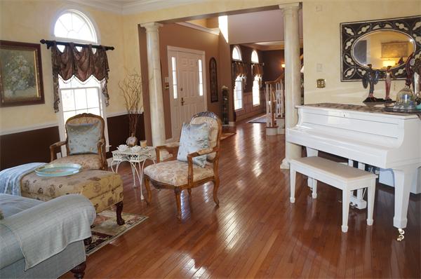 32 Cherokee Road Canton, MA 02021 - Photo 8 of 30 a living room with furniture a mirror and wooden floor