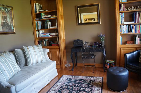 32 Cherokee Road Canton, MA 02021 - Photo 10 of 30 a living room with furniture a rug and a book shelf