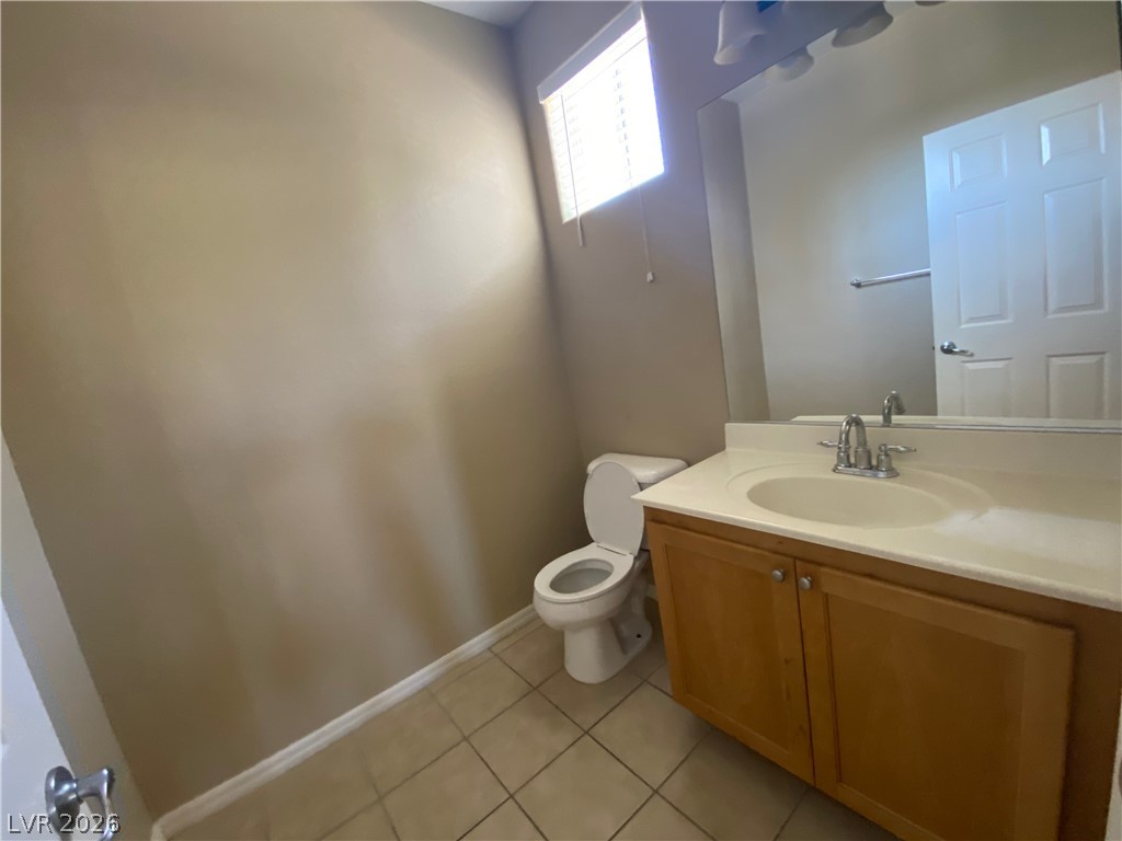 489 Foster Springs Road Las Vegas, NV 89148 - Photo 9 of 30 A well-appointed half bath features a vanity with ample counter space and a large mirror.