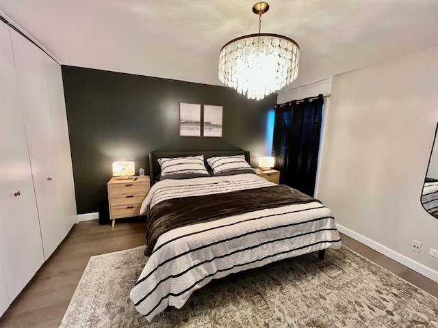 1601 Maple Terrace, Unit 3B Lisle, IL 60532 - Photo 5 of 6 a bedroom with a bed and a chandelier