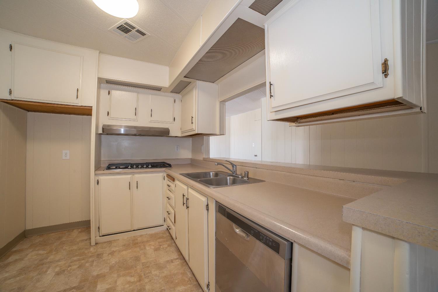 1200 South Carpenter Road, Unit 71 Modesto, CA 95351 - Photo 15 of 27 a kitchen with stainless steel appliances granite countertop a sink stove and refrigerator