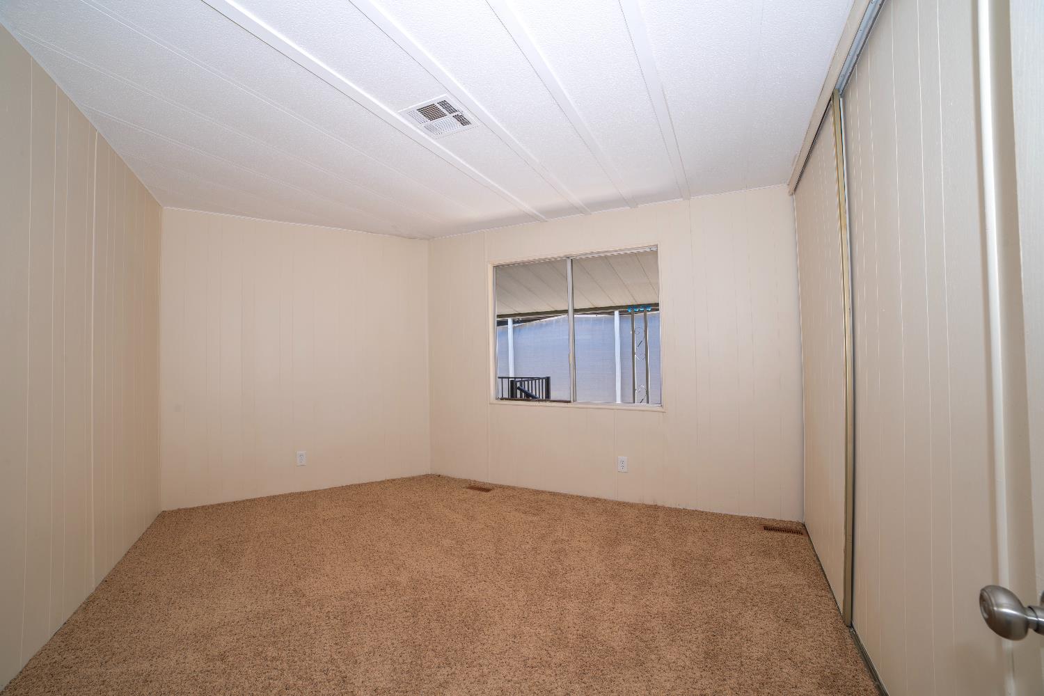 1200 South Carpenter Road, Unit 71 Modesto, CA 95351 - Photo 17 of 27 a view of an empty room with a window