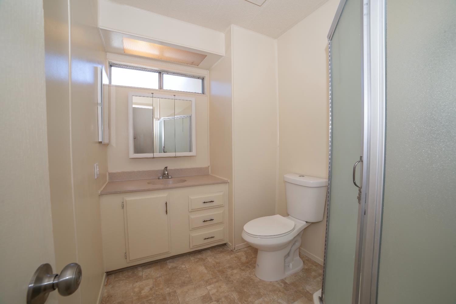 1200 South Carpenter Road, Unit 71 Modesto, CA 95351 - Photo 18 of 27 a bathroom with a toilet a sink and mirror