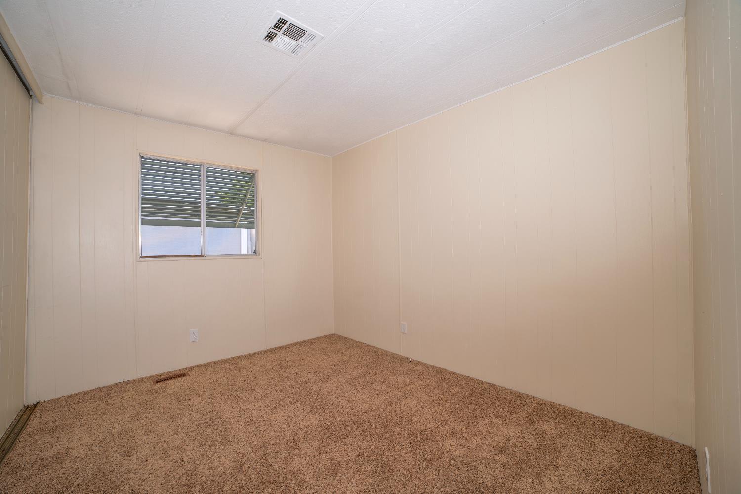 1200 South Carpenter Road, Unit 71 Modesto, CA 95351 - Photo 20 of 27 an empty room with a window