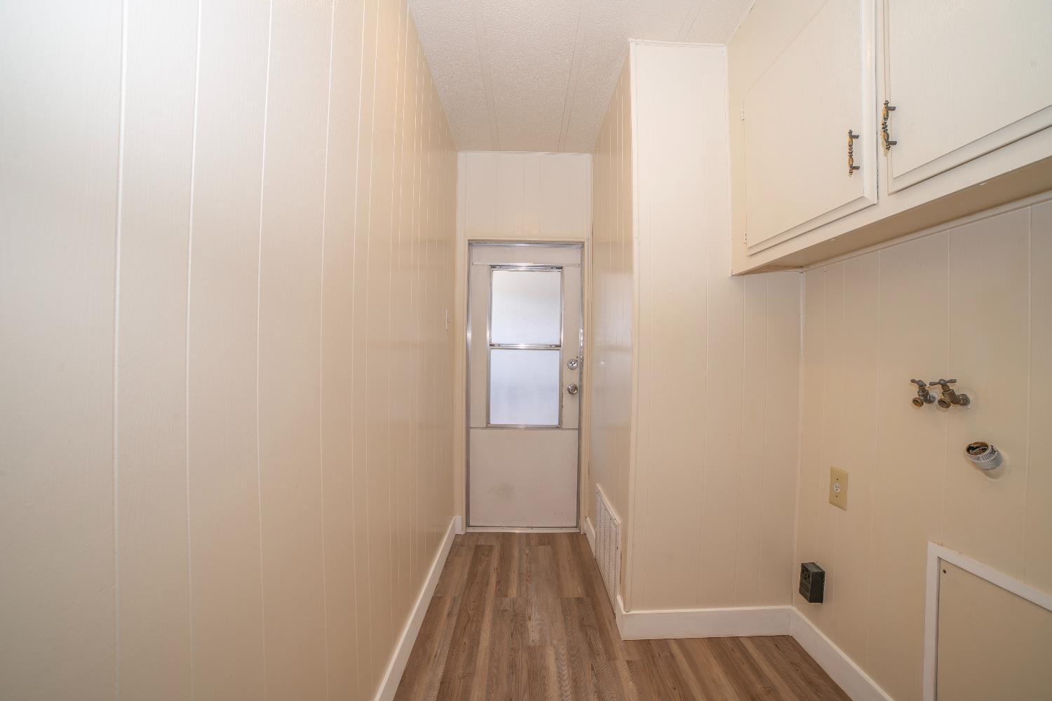 1200 South Carpenter Road, Unit 71 Modesto, CA 95351 - Photo 21 of 27 a view of a hallway with wooden floor