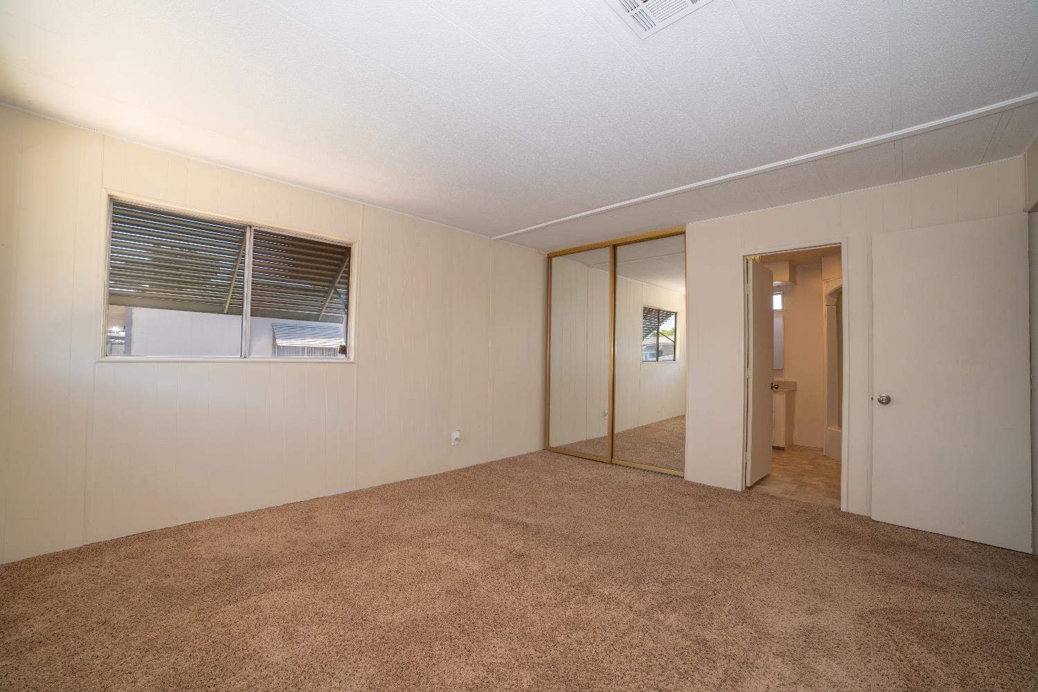 1200 South Carpenter Road, Unit 71 Modesto, CA 95351 - Photo 22 of 27 a view of an empty room with closet and a window