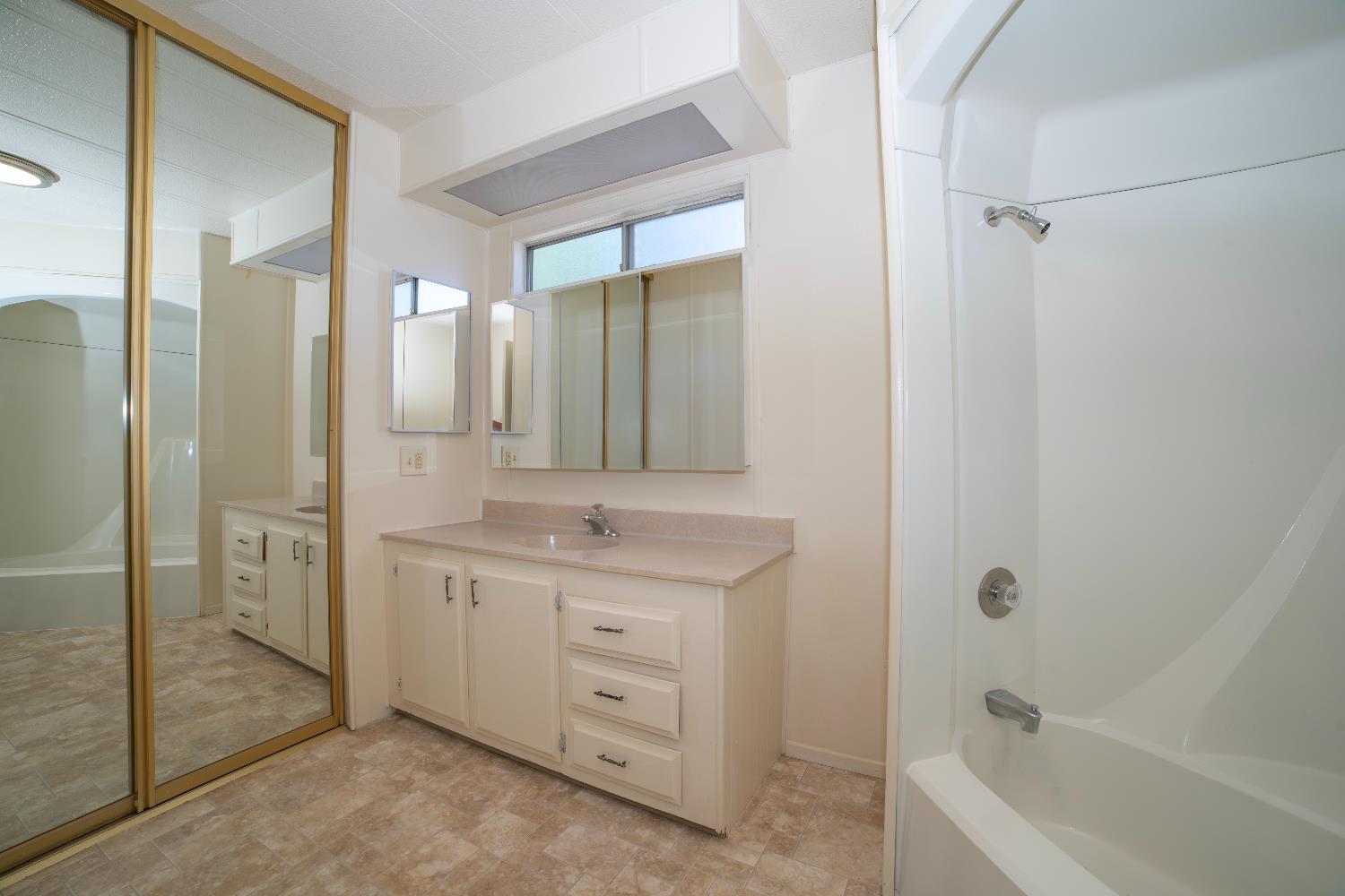 1200 South Carpenter Road, Unit 71 Modesto, CA 95351 - Photo 23 of 27 a bathroom with a tub a sink and shower