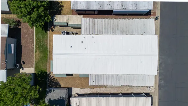 a view of a house with wooden fence