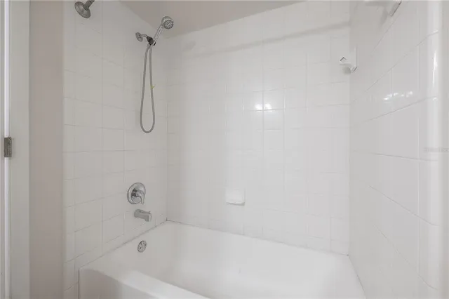 a bathroom with a sink a light fixture and a mirror