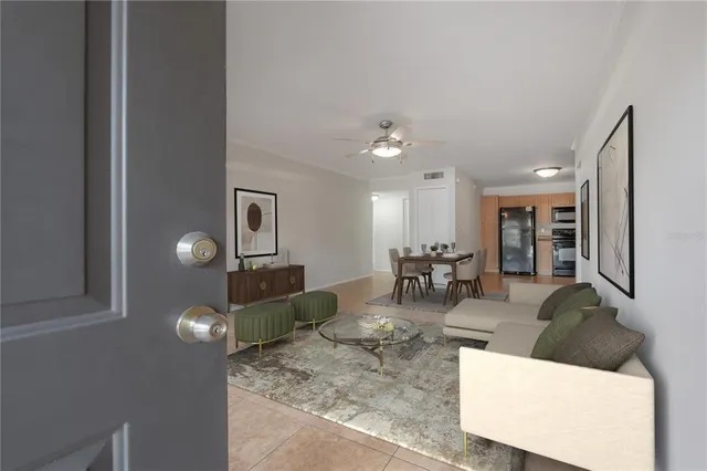 a living room with furniture and chandelier