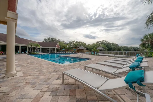 a view of a swimming pool with a yard