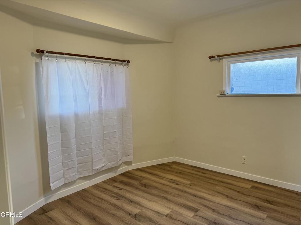 3951 East Cesar E Chavez Avenue Los Angeles, CA 90063 - Photo 2 of 13 a view of an empty room with wooden floor and a window