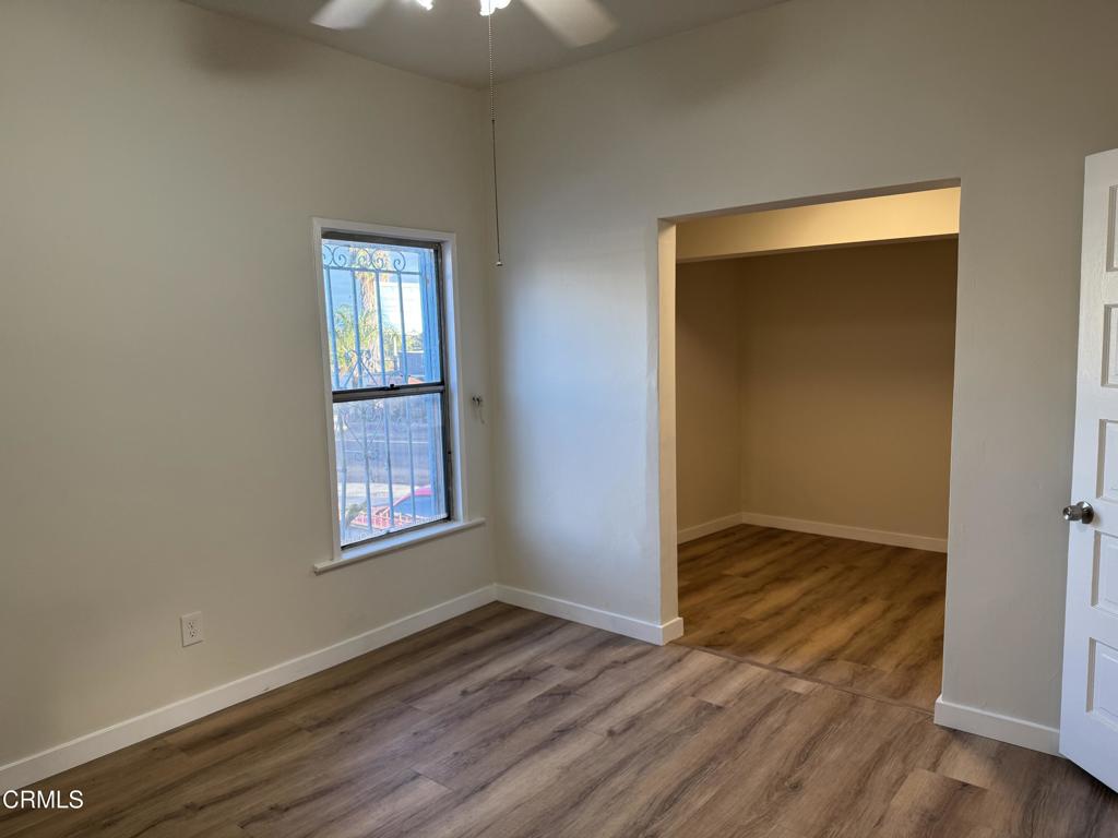 3951 East Cesar E Chavez Avenue Los Angeles, CA 90063 - Photo 3 of 13 an empty room with wooden floor and windows
