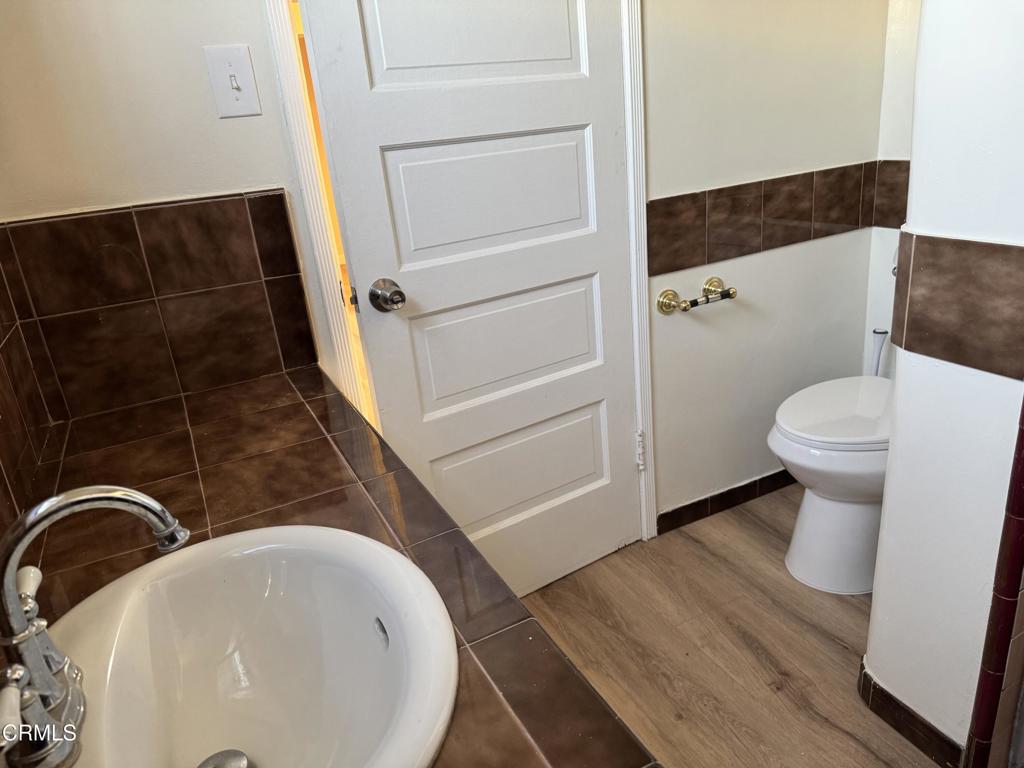 3951 East Cesar E Chavez Avenue Los Angeles, CA 90063 - Photo 7 of 13 a bathroom with a sink and a mirror