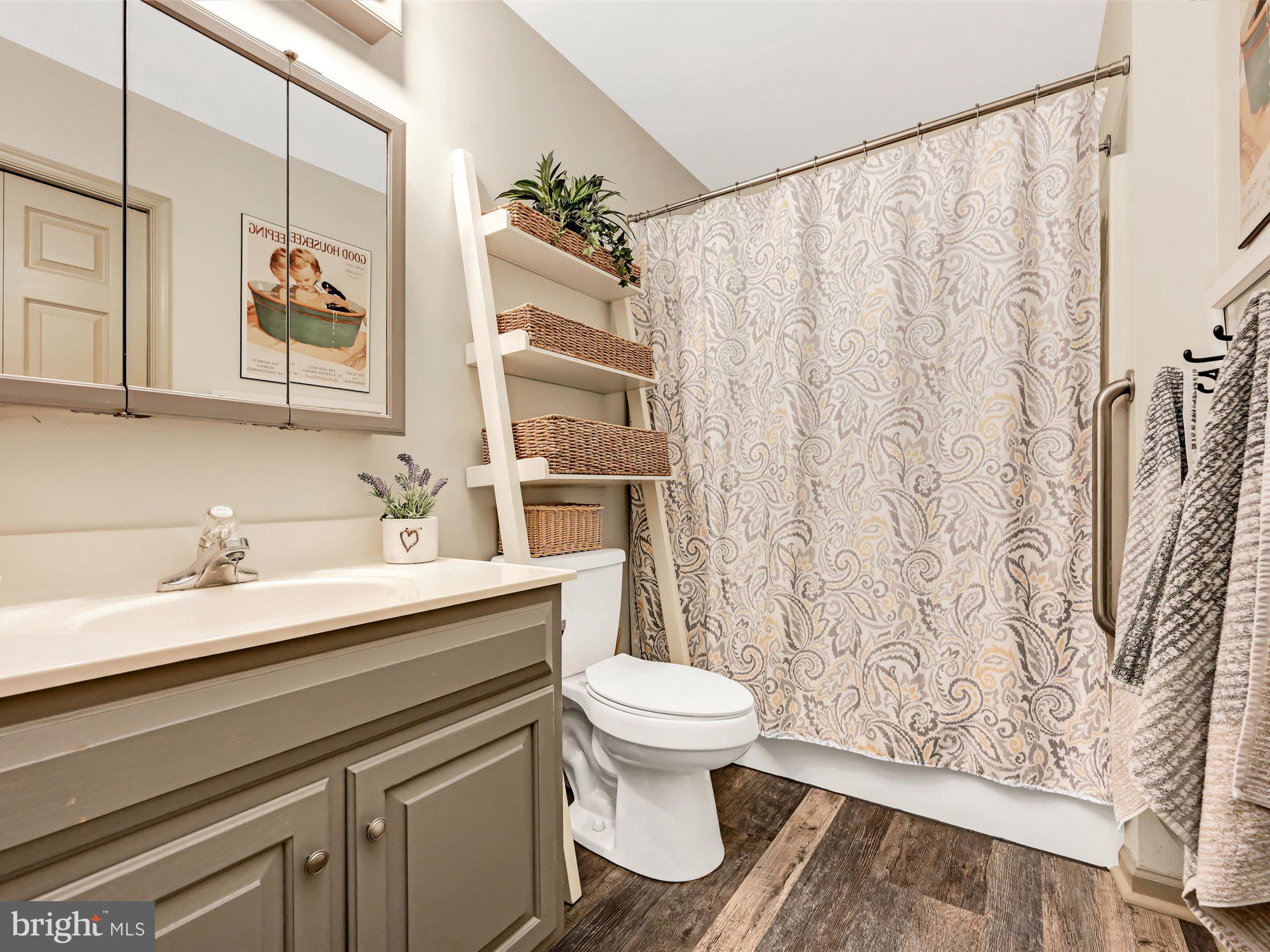 329 North New Street Lititz, PA 17543 - Photo 13 of 20 a bathroom with a granite countertop sink a toilet and a mirror