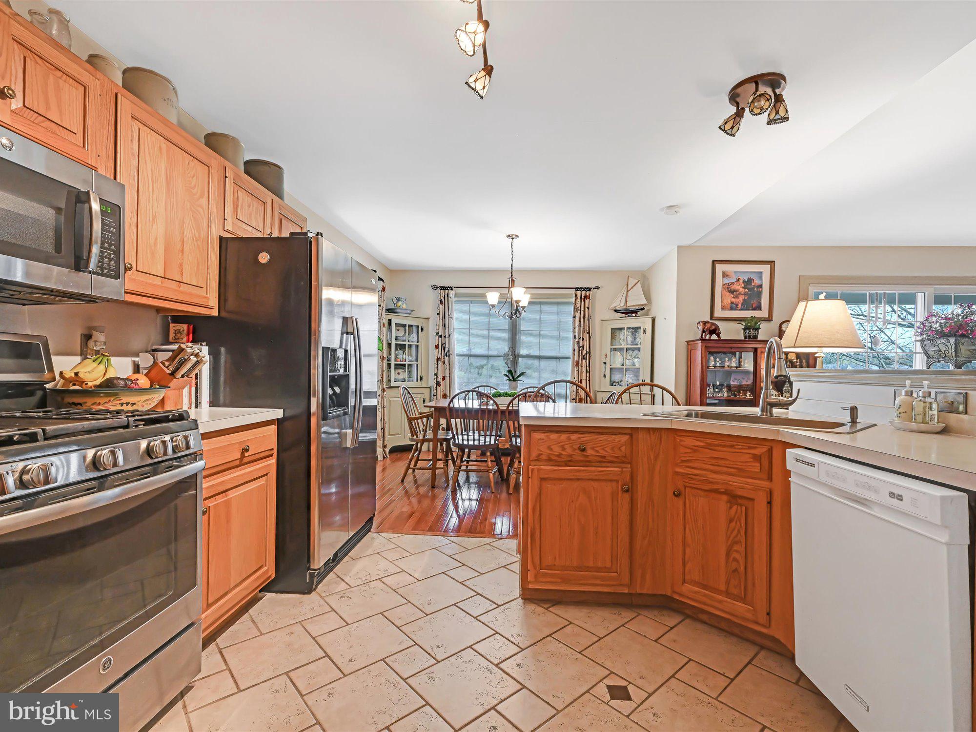 329 North New Street Lititz, PA 17543 - Photo 5 of 20 a kitchen with stainless steel appliances granite countertop a stove top oven a sink dishwasher and cabinets with wooden floor
