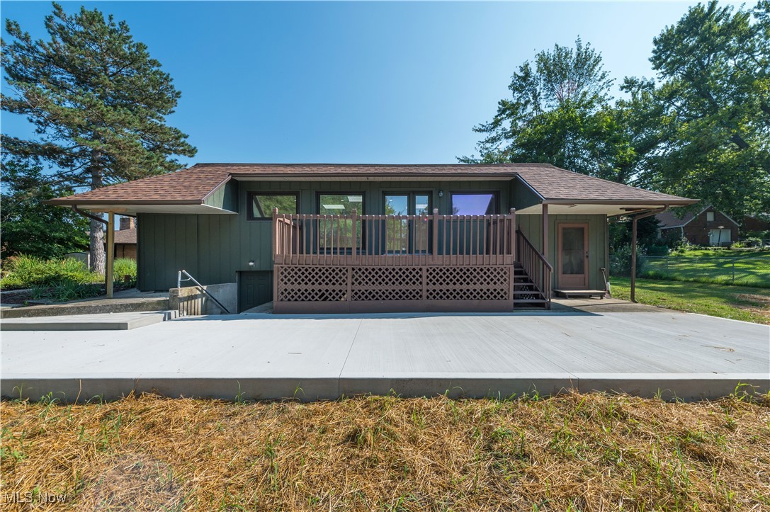 433 Chestnut Road Independence, OH 44131 - Photo 5 of 50 Rear view of property featuring a shingled roof and a wooden deck
